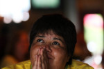 Minerva Lopez prays as she watches the end of the Athletica's game at a watch party at Amsterdam Tavern in St. Louis. The Athletica took on the Washington Freedom in Washington DC. The freedom came out on top 1-0.