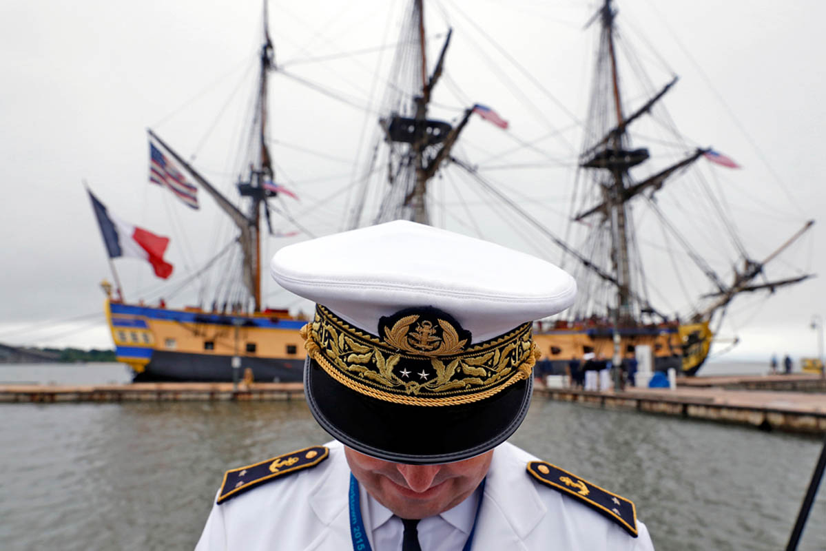 Rear Admiral Heivé Blejean of the French Navy stands on the pier after the French tall ship Hermione docks at Yorktown Friday morning.