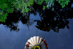 Pilot Reed Basley's hot air balloon is reflected in a body of water near Lanexa Monday evening. 