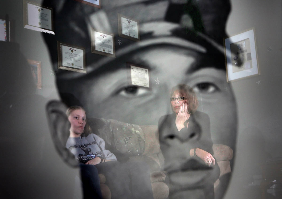 Pfc. Jordan Goode's wife, Aubrey Goode, left, and mother Sheri Goode, right, are reflected in the glass of his Army portrait painting. Jordan Goode was killed in Afghanistan in August of 2007 while serving with Army. The painting was done by artist Michael Reagan.