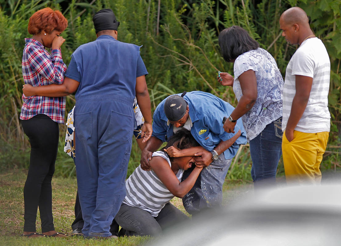 Family members grieve at the scene of where two Newport News' men drowned while swimming in Deep Creek Tuesday afternoon. 