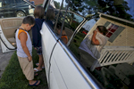 Jessica Leitch, right, begins to cry as Benjamin Leitch, left, and Gracelyn Leitch enter the family's van Sunday morning July 17, 2016 to move to Missouri from Smithfield. Jessica is leaving behind her husband John Leitch in hopes of finding better special education for Benjamin. 
