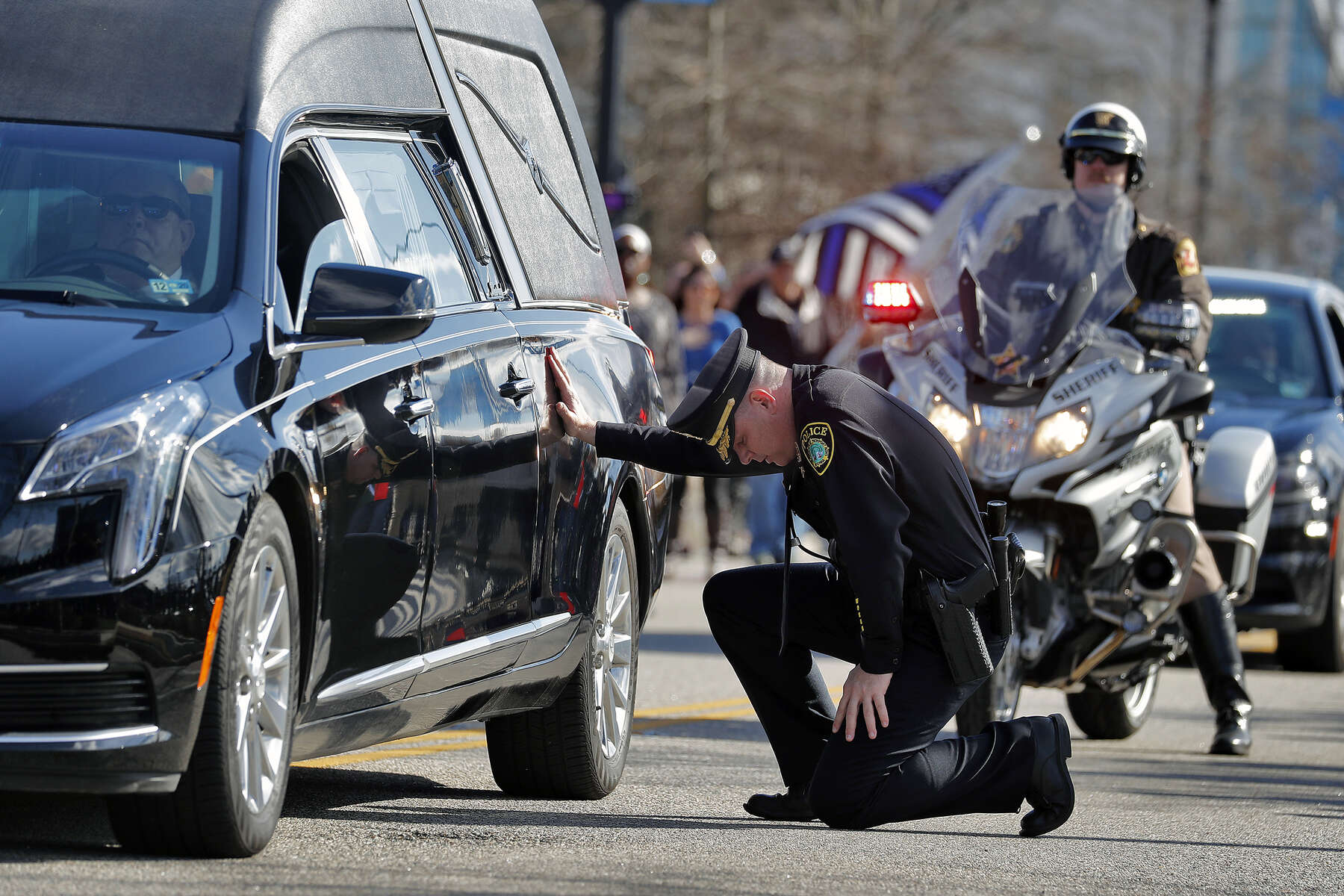 Newport News Police Chief Steve Drew falls to one knee and touches the hearse carrying officer Katherine Thyne outside of the Newport News Police Department South Precinct during a procession Saturday afternoon January 25, 2020. Officer Thyne died Thursday night after being dragged by the car of a man who she and another officer were questioning. On Saturday, the Newport News Police Department transported officer Katherine Thyne from the Medical Examiner’s Office in Norfolk to Altmeyer Funeral Home in Newport News.