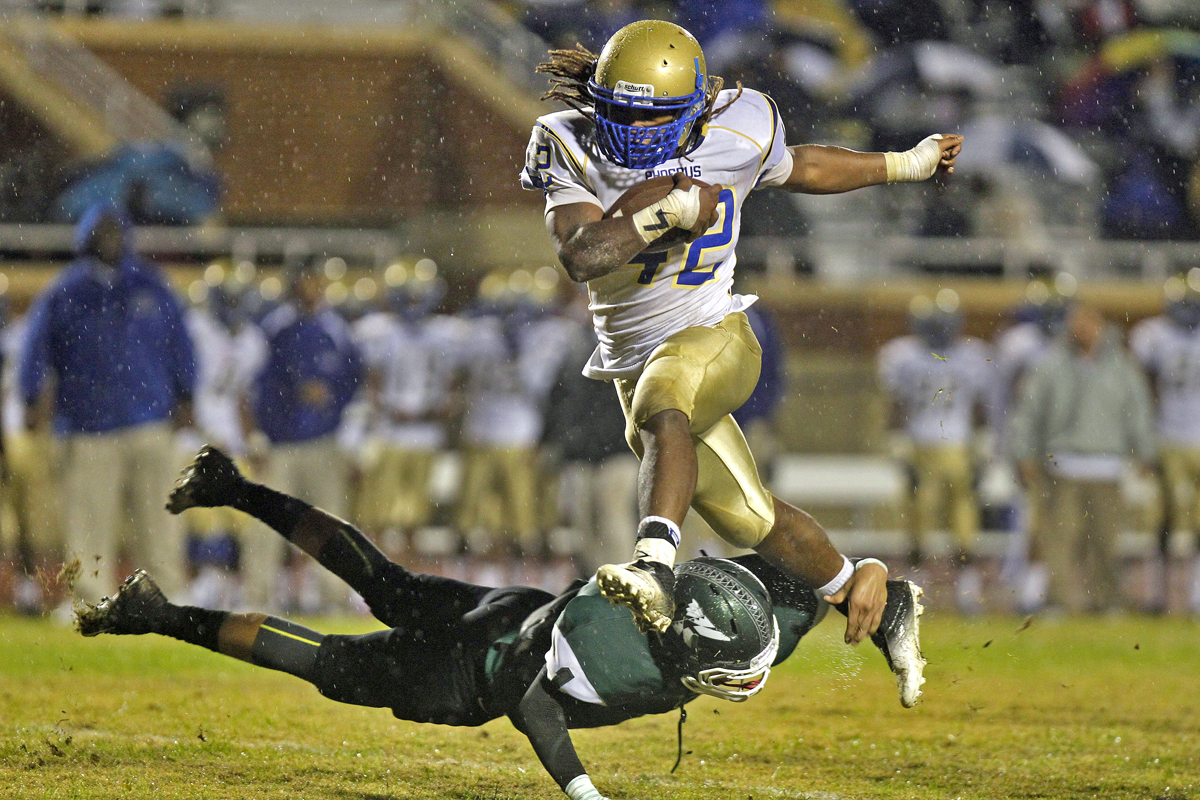 Phoebus' Marshawn Williams, right, hurdles Kecoughtan's Kashawn Lynch in the air during Friday's game at Darling Stadium.