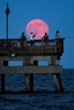 A super moon rises over the Buckroe Fishing Pier Saturday evening July 12, 2014. 