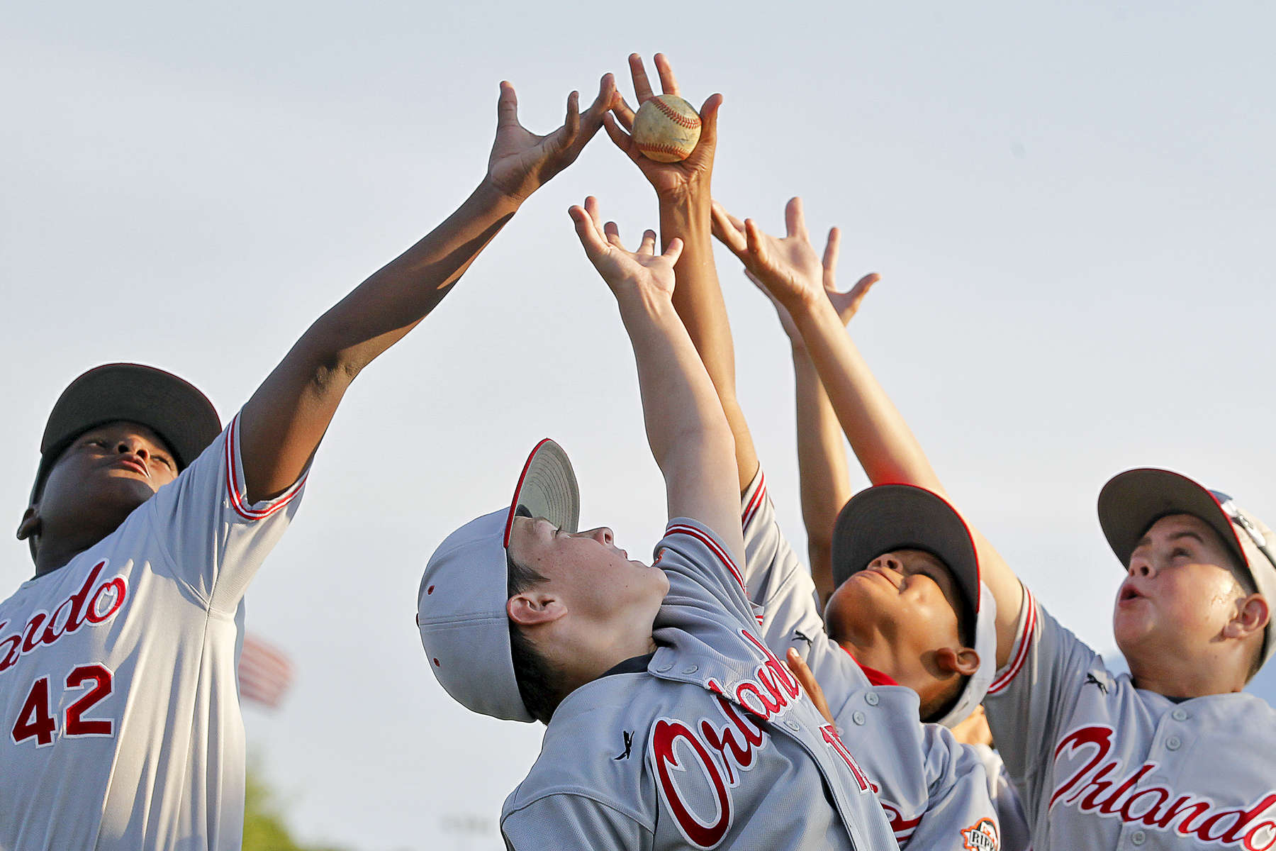 From left Orlando Storm's Jackson Stephens, Tanner Reid, Tank Kelley and Nolan Juvers jump to catch a ball before the start of Tuesday's opening ceremony of the Cal Ripken Southeast Regional baseball tournament July 12, 2016. 