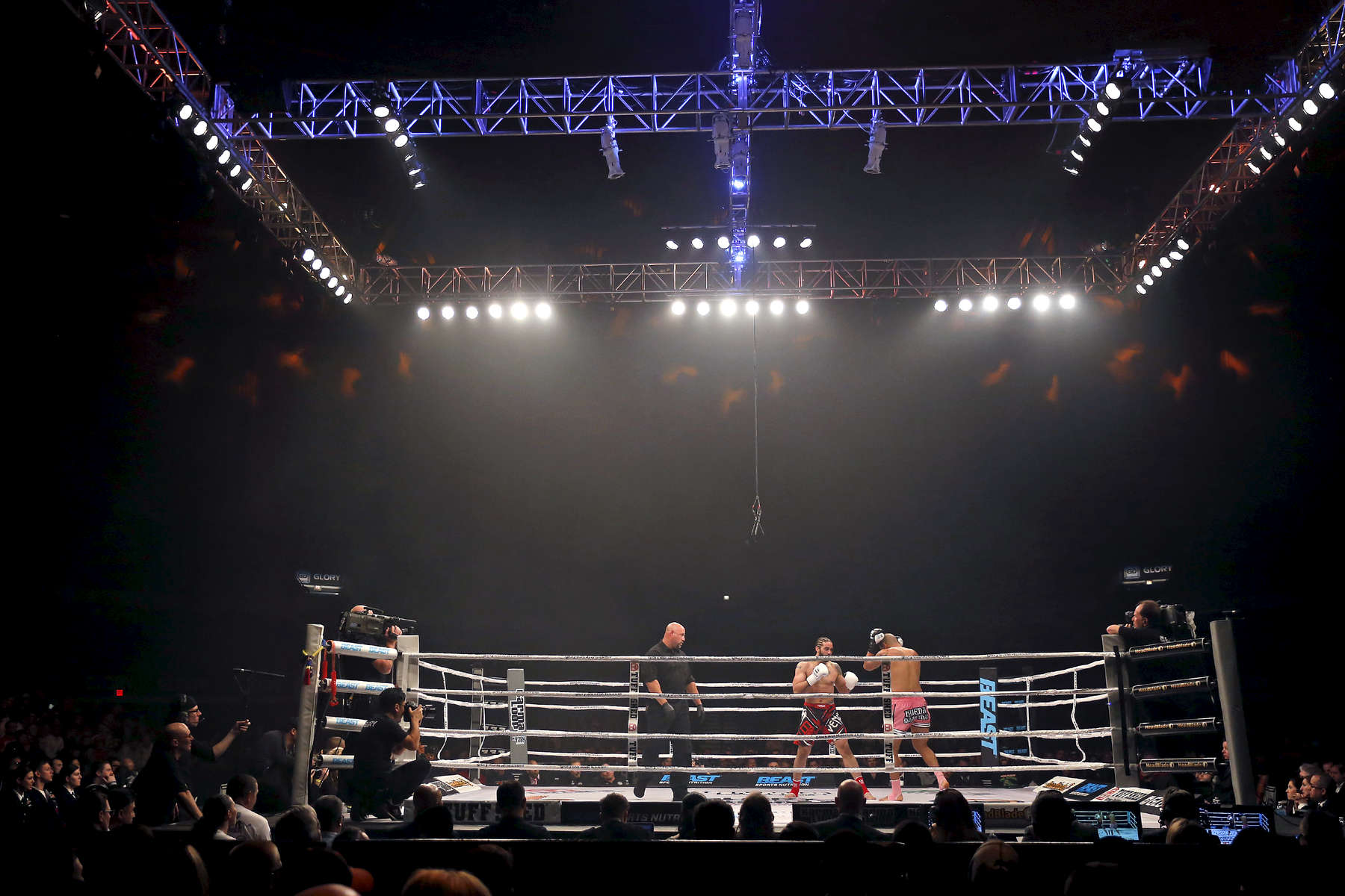 Myron Dennis, right, and Brian Collette, center, dance around the ring during Friday's SuperFight presented by Glory Sports International at the Hampton Coliseum. 