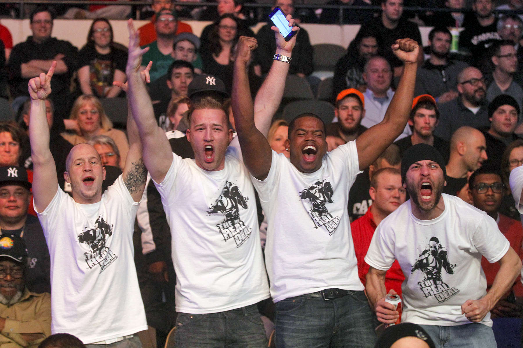 Fans of Raymond Daniels cheer as he competes against Jonatan Oliveira during Friday's tournament presented by Glory Sports International at the Hampton Coliseum. 
