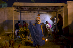 Margarita Jimenez stands on a grave in Panteon Viejo Xoxocotlán during Day of the Dead.