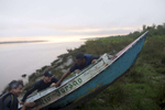 Marcio Pinheiro, Ivan Moreira and Marcio Vitello push up the boat from the Amazon River.