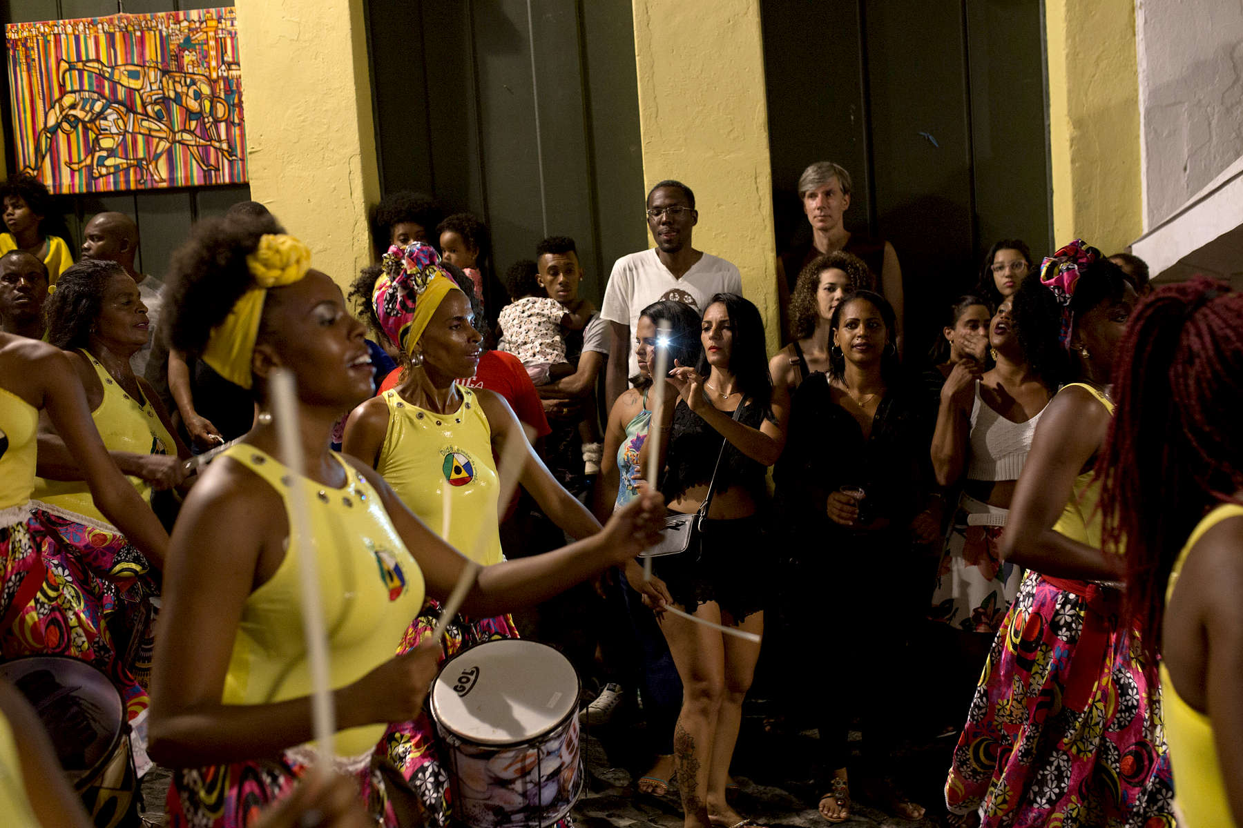 A group of onlookers watch a Didá performance on the street outside Project Didá in Salvador's historic neighborhood, Pelourinho.
