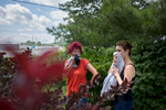 Urszula Urbaniec, left, and her daughter Izabela, neighbors who were evacuated from their home in the area, cover their faces against the smoke as they walk to look at the massive fire that consumed several industrial buildings including a Toyota service center in North Brunswick Township, NJ July 22, 2015.(Kevin Hagen for The Wall Street Journal)