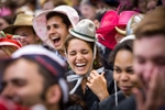 Graduating Seniors wearing colorful hats, laugh during a speech at Class Day, the day before commencement at Yale University. 