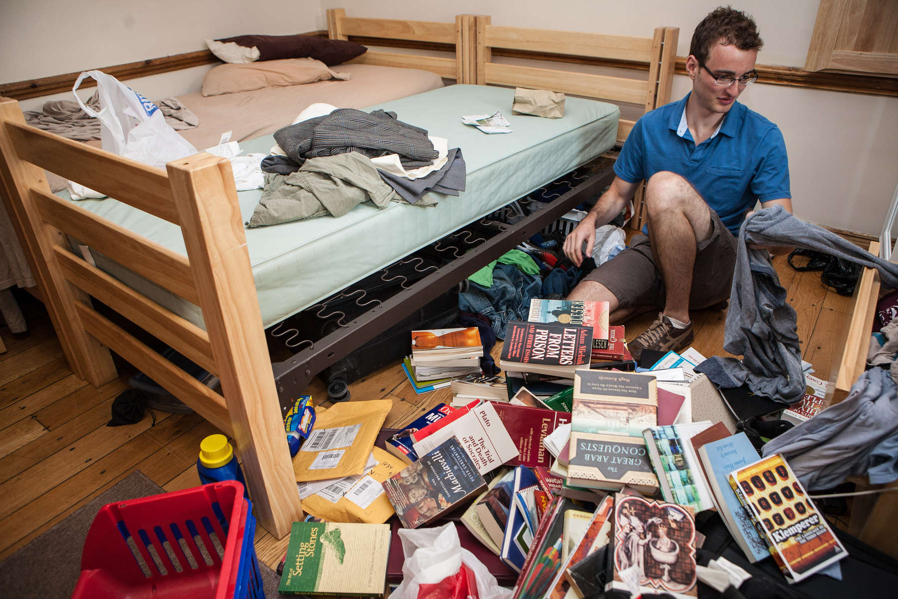 A Senior at Yale University sorts through his belongings in his dorm room at Davenport College. Yale Alumni Magazine