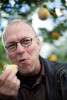 Eric Larson, manager of the Marsh Botanical Gardens eats an orange picked from a tree grown in one of the greenhouses. 