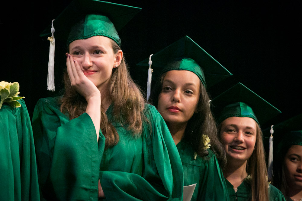 A student at The Mandell School in Manhattan, collects herself during a graduation speech. 