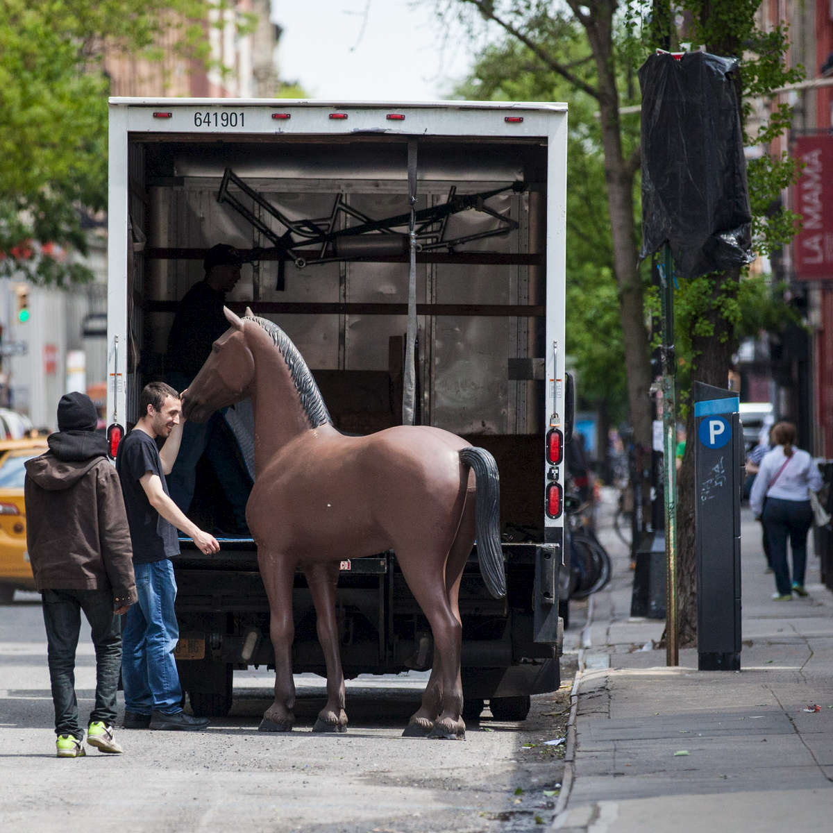 A prop from a Kentucky Derby party gets loaded back onto a truck on 4th Street between 2nd and Bowery