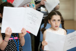 The daughter of an alumni sings during a glee club rehearsal.Yale Alumni Magazine