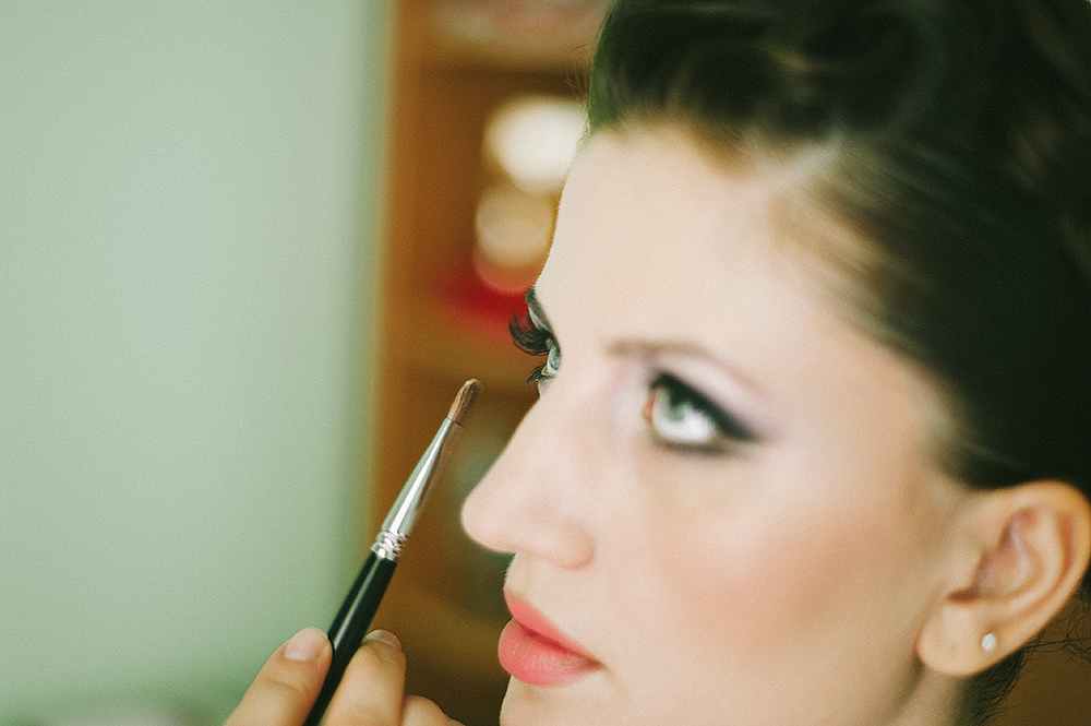 Daniela, a young beautiful bride applying wedding make-up by professional make-up artist