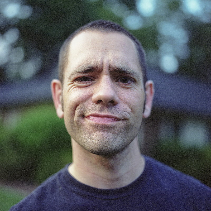 A portrait of Joel Hopler with short hair