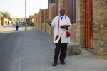 Rev. Frans Kgolane, 61, who leads a congregation at The Baptist Apostolic Church. He was on his way home after service. The long cross is very common among the men, whether they are the ministers or simply a part of the congregation. The staff conveys that Jesus was a shepherd.