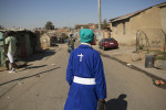 A woman heads for church mid-morning.