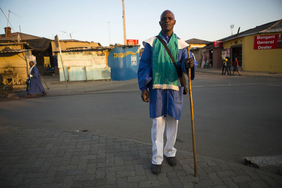Wilson Mabasa, 55, poses for a photographer. He is a member of Apostles Church. He was headed home after Sunday service ended.