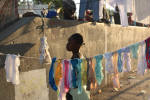 Port Au Prince, Haiti, This woman hangs a clothes to dry on a line in an area of Champ de Mars park in the city center. She is one of hundreds who have built tent cities in this park after the devasting earthquake on January 12th destroyed their homes.Photo by Ozier Muhammad/The New York Times