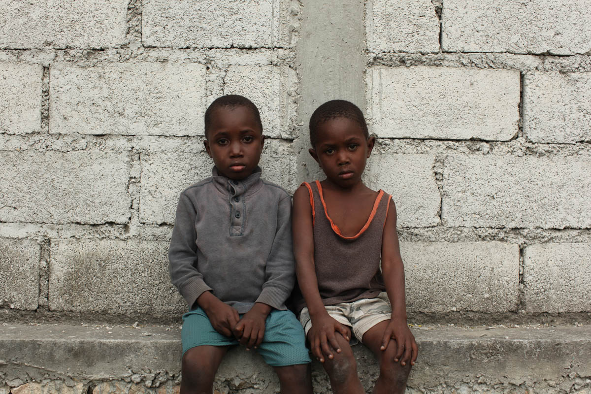 Croix Des Bouquets, Haiti - Orphans of the January 12th earthquake are gathered in a field next to Lycee Jacques, a primary school. They are under the care of FRADES, a grass organization which is providing foster care. Portrait of brothers Enso, 8 and Edno Edmonds, 6.  - Ozier Muhammad/The New York Times