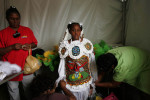 A girl is dressed in a Mardi Gras Indian costume in a tent at the first Jazz and Heritage Festival since Katrina damaged the Crescent City.