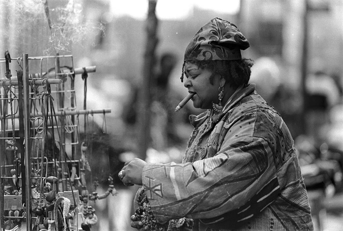 March, 1993 - Katirah Hikmah, a jewelry, incense and trinkets vendor, finishes preparing her sells display on 125th street.