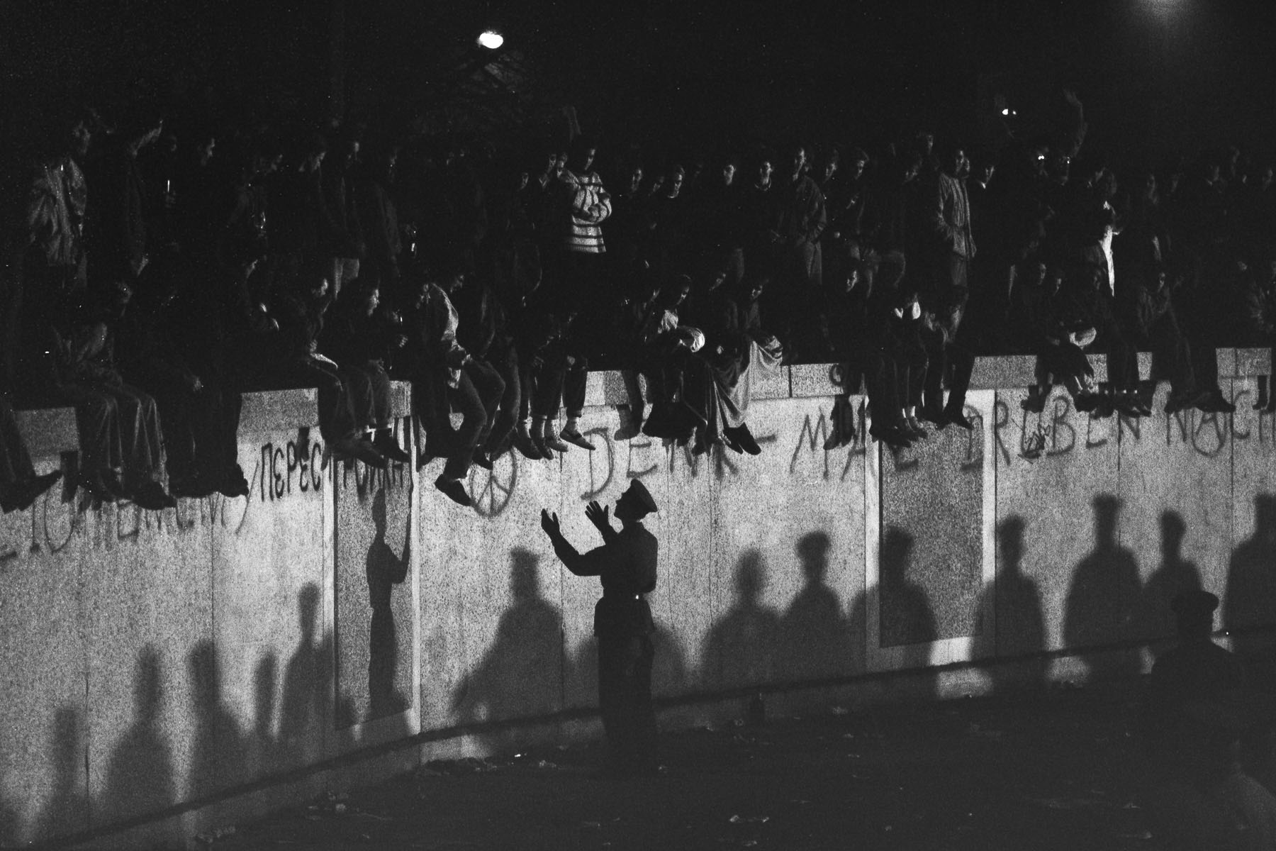 When the opening of the border is announced West-Berliners gather and climb on the wall next to the Brandenburg Gate on November 10, 1989