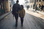 Couple in a street of the Muslim area of Mostar besieged by the Croatian militias in January 1994