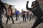 Anti-government demonstrators throw stones during a clash with President Mubarak's supporters on Tahrir Square on Thursday February 3 2011