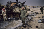 U.S. soldier stands in front of a destroyed Iraqi tank in February 1991