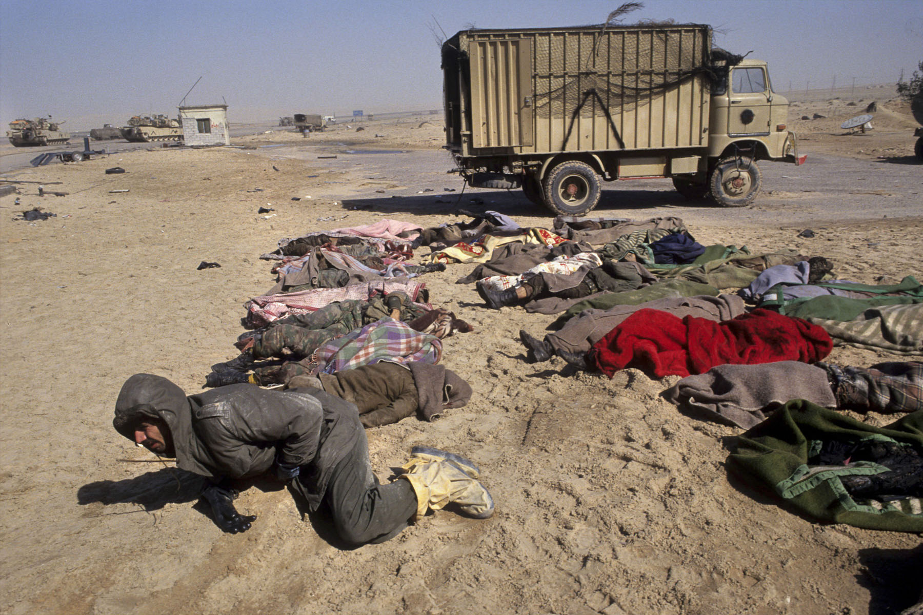 An Iraqi prisoner cries by his friends’ corpses on the road to Basra in February 1991