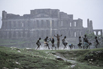 Children play under the tropical rain in front of the Sans-Souci palace built in 1806 by King Christophe and destroyed by the 1842 earthquake in October 2003