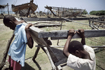 Children on a boat building site. Boat people will use some of them to emigrate to the US. 2003