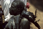 A believer about to sacrifice a rooster during the annual pilgrimage dedicated to the loa (spirit) Ogou Feray in July 1994