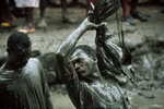 A believer sacrifices a rooster during the annual pilgrimage dedicated to the loa (spirit) Ogou Feray in July 1994