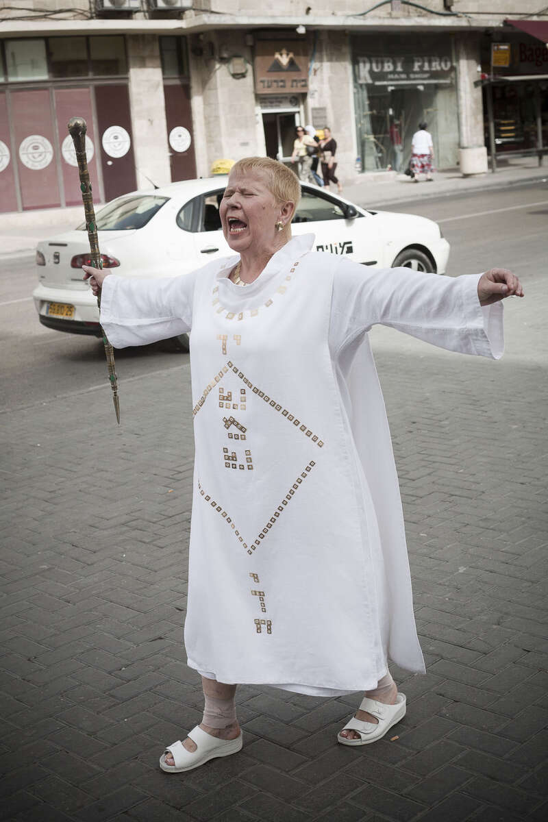 A Western woman preaches in the street in March 2008