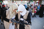 Libyan women demonstrate with false weapons to ask more military aid in April 2011