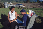 A man tattooes a traditional Maori moko on a harm of a woman in May 2000