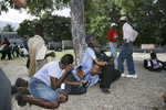 Journalists caught in the fire during a demonstration against President Aristide on the Champ de Mars in November 2003