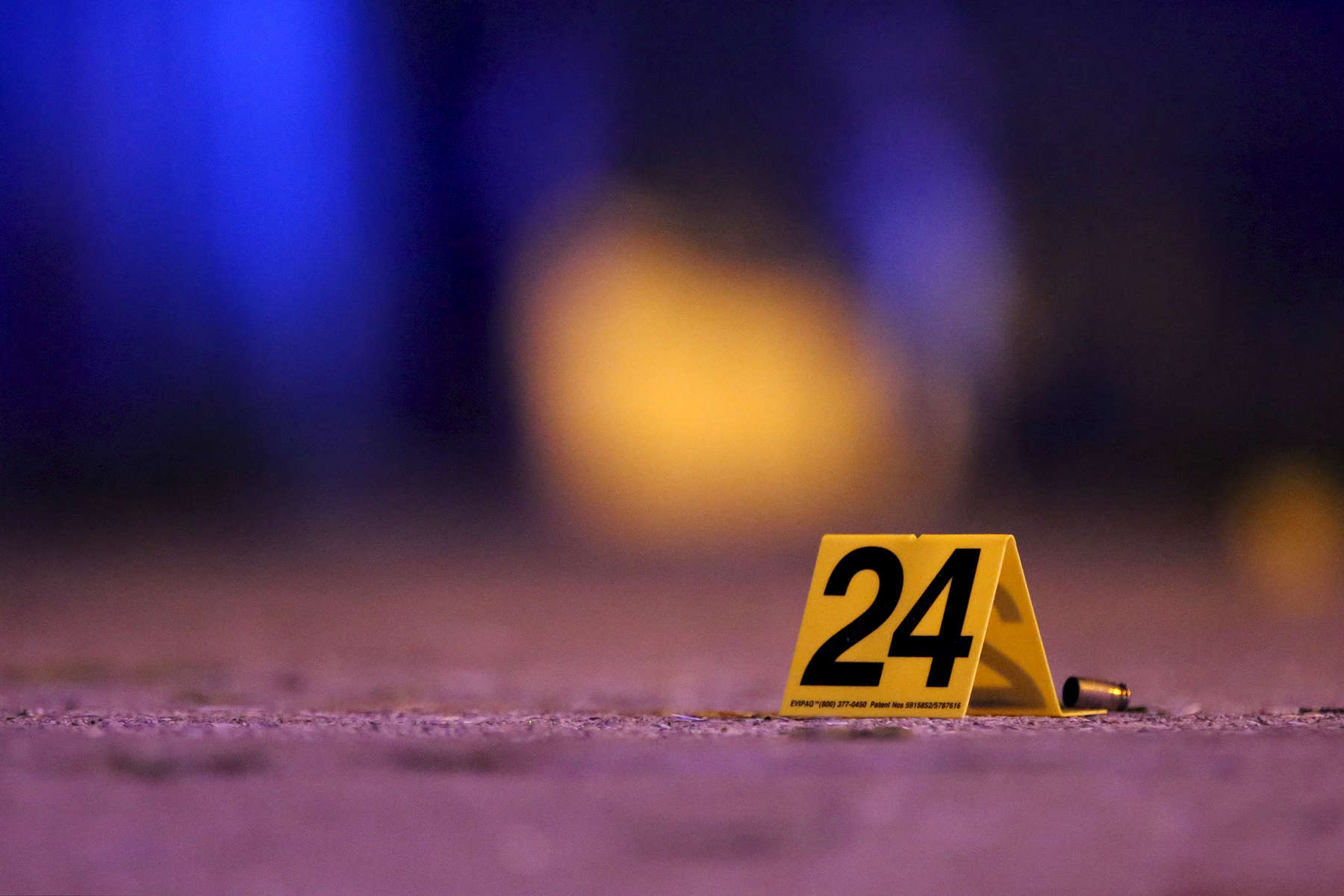 An evidence marker sat near a shell casing at the scene where four people were shot in the Austin neighborhood of Chicago.