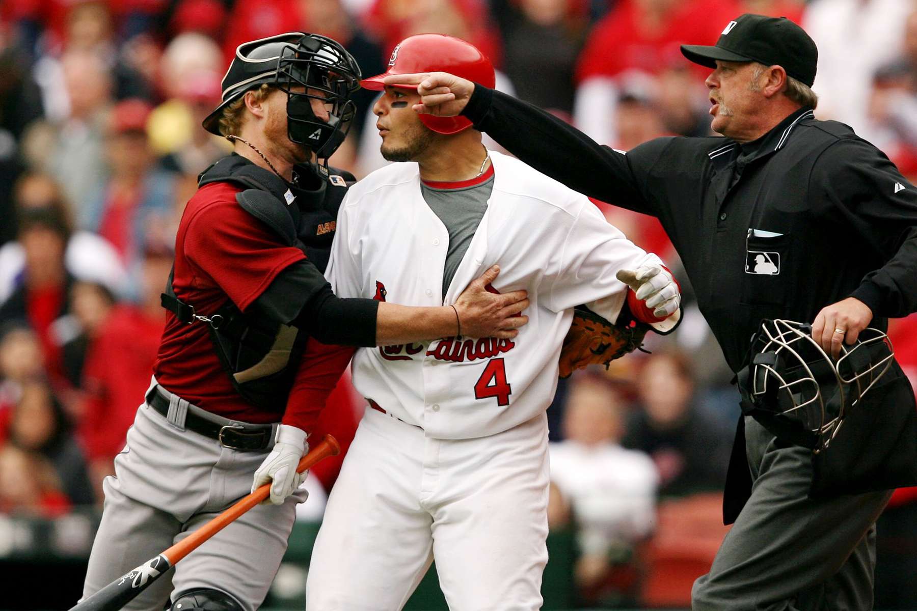 Houston Astros catcher Justin Towles tried to restrain St. Louis Cardinals' Yadier Molina as he charged towards pitcher Brandon Backe over a questionable inside pitch during an MLB game at Busch Stadium in St. Louis. 
