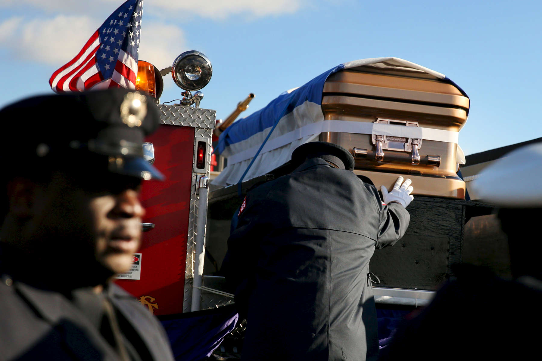 A firefighter touched the coffin of fallen firefighter Daniel Capuano as it rest on the back of an engine following funeral services at St. Rita High School in Chicago. Capuano, a 15-year veteran, was searching the second floor of a fire in a vacant warehouse when he fell down an open elevator shaft and died hours later. 