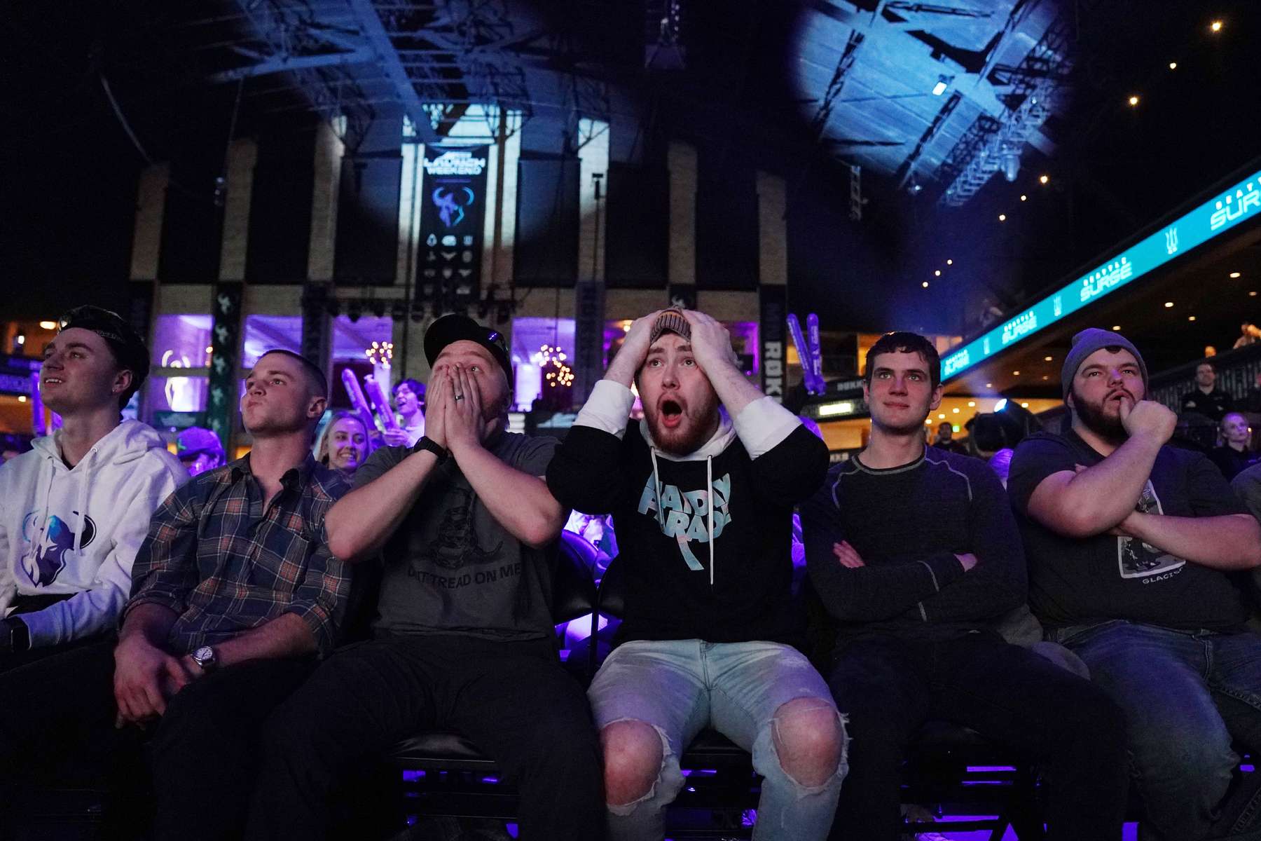 Friends, from left, Andrew Schafer, Scott Weinand, Phillip Fisher (with his hands on his head), and Abe Harder watched as the Seattle Surge played the Florida Mutineers in Call of Duty during a three day tournament at the Armory in downtown Minneapolis. 