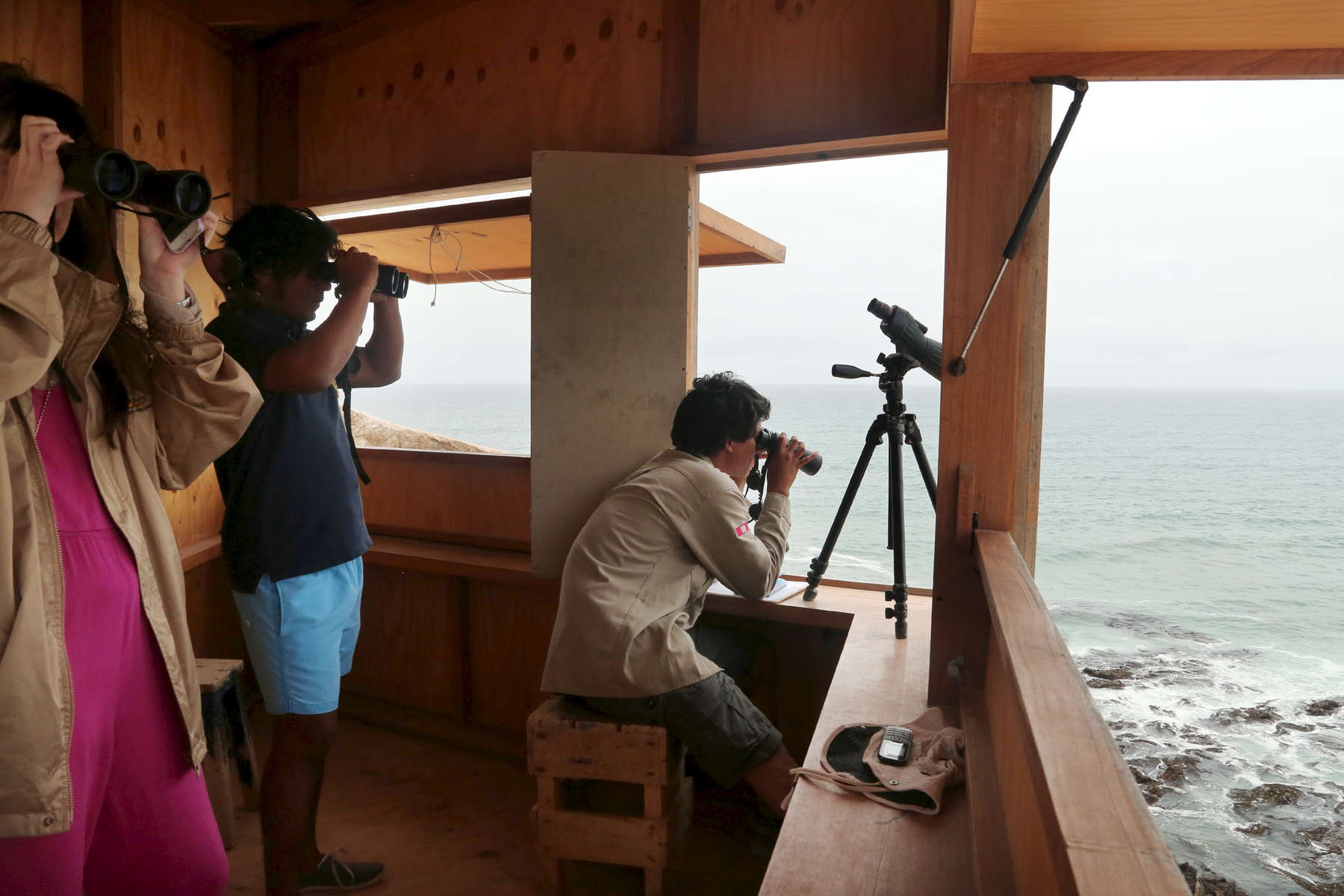 Jimena Andrés, left, looked out from a cliffside blind while taking a tour at the Punta San Juan coastal reserve near San Juan de Marcona in Peru. Ecotourism has not only brought about awareness to the area but also financial contributions that are helping Punta San Juan sustain itself.