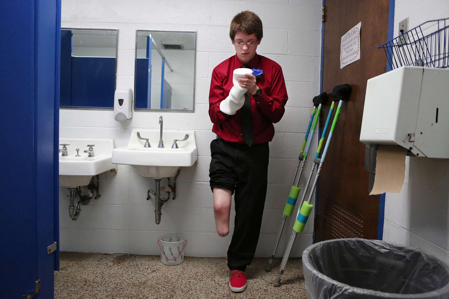 Seth Melvin, 15, who was born with a deformed leg and foot which he decided to have amputated, adjusted his prosthetic liner before his eighth grade graduation at Cornell Grade School in Cornell, Ill. Melvin accomplished one of his goals, to walk with a prosthetic to accept his diploma at graduation.
